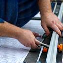 Engineer measuring gutter dimensions