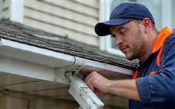 Technician overseeing gutter installation